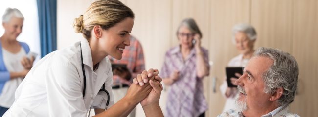 smiling-female-doctor-holding-hands-with-disabled-2023-11-27-05-14-25-utc