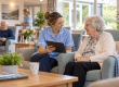 How Technology is Transforming Nursing Homes in Ireland - Nurse and resident sitting and chatting